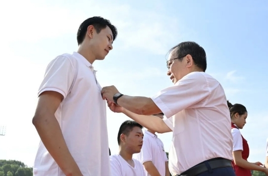 柳和生为新生代表佩戴校徽