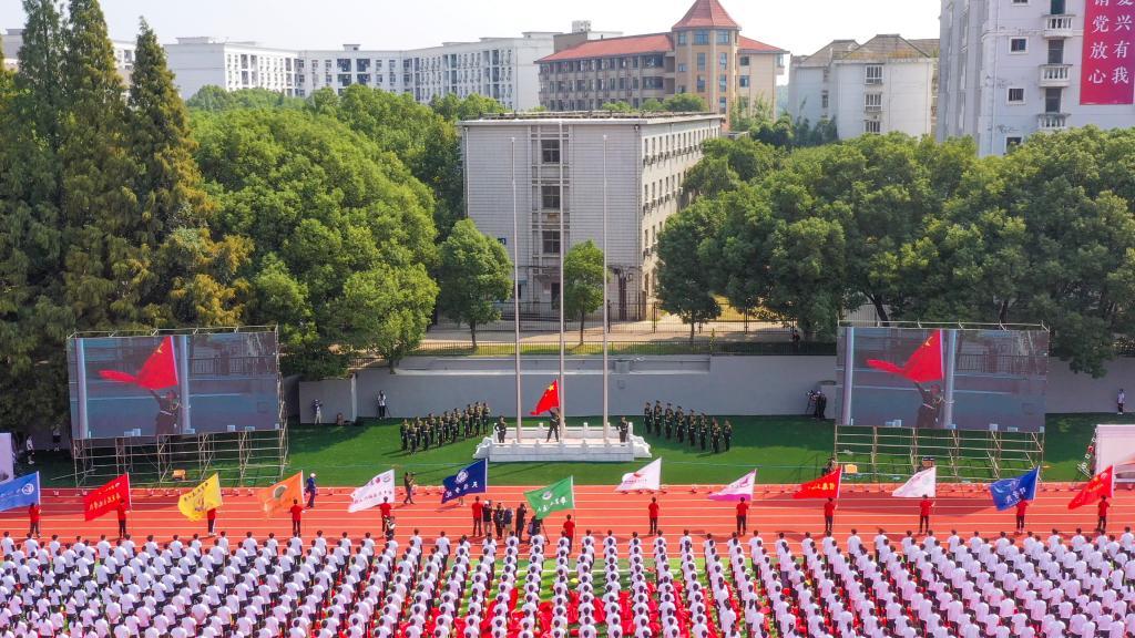 全体起立,升国旗,奏唱国歌。